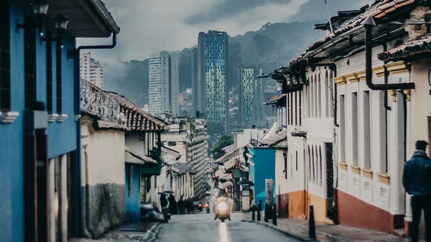 Calle del centro histórico de Bogotá con edificios y tráfico al fondo